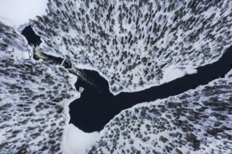 Aerial view over Myllykoski water mill along the river Kitkajoki in winter, Oulanka National Park,