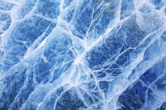 Close-up of blue ice, made of compressed snow, structure showing cracks and fissures inside