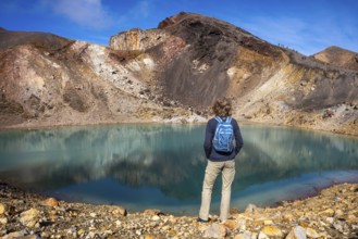 A hiker at one of the Emerald Lakes and Red Crater, Panorama, Tongariro alpine crossing, Tongariro