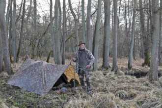 Camp of a nature photographer, nature photographer in front of his camouflage camp in the
