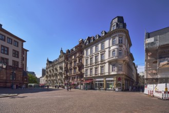 Historic buildings, old residential buildings and commercial buildings, paving stone square,