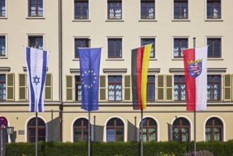 Flags, Israeli flag, European flag, German flag, flag of Hesse, flagpoles, façade with windows and