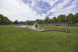 Green area, cascade fountain, bowling green, lawn, trees, back light, side light, cloudy,