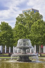 Cascade fountain, garden, tree, lawn, bowling green, high-rise building, blue sky, cumulus clouds,
