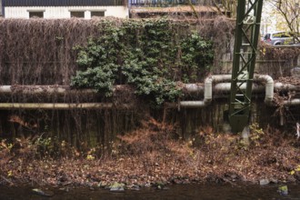 District heating pipeline in front of old industrial buildings on the banks of the Wupper,