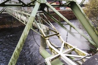 District heating pipeline over the Wupper river, steam escapes, Wuppertal, Germany