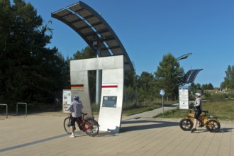 Cyclists at the symbolic gate on the border between Germany and Poland on the Europa Promenade,