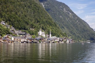 A, Hallstatt, An idyllic lakeside village with a church, surrounded by wooded mountains, Austria
