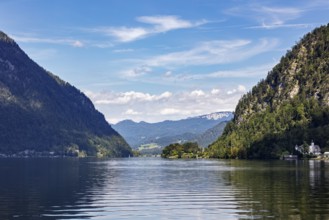 A, Hallstatt, A quiet lake with mountain scenery under a blue sky with cloud formations, Austria