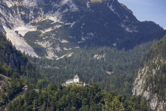 A, Hallstatt, A majestic castle perched high on a wooded mountain peak, Austria