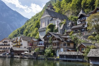 A, Hallstatt, picturesque village with characteristic wooden houses on the lakeside in front of a