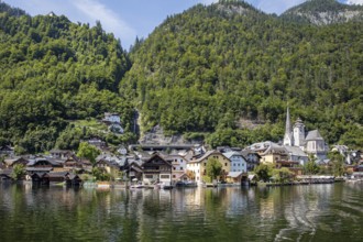 A, Hallstatt, village with traditional buildings and lush green landscape, Austria