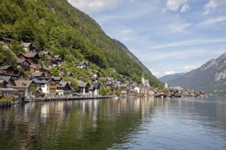 A, Hallstatt, panorama of a picturesque lakeside village with mountains in the background and a