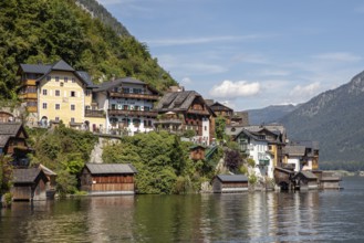 A, Hallstatt, picturesque buildings and traditional houses along the water, surrounded by