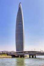 Modern skyscraper on a river with a bridge under clear sky, Mohammed VI Tower in Rabat in Morocco