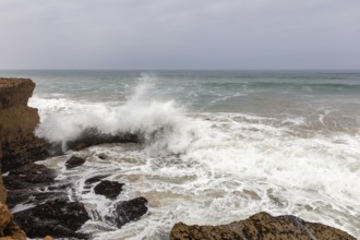 Powerful waves crash against rocks