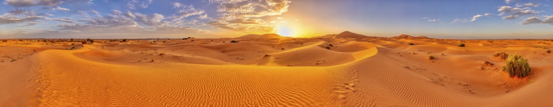 Sunset over a vast desert landscape with sand dunes, Sahara, Morocco