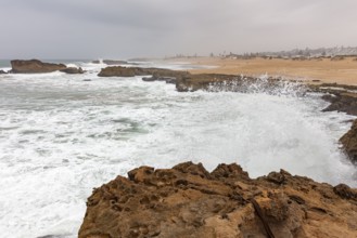 Ocean surf against rocks on a stormy coastline