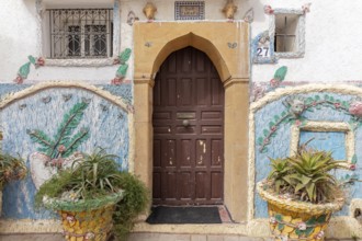 Traditionally decorated house entrance with plants and floral patterns