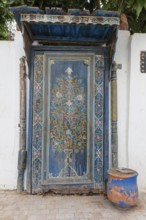 Elaborately decorated blue door with oriental patterns, the oldest door in the Kasbah of Oudaia in