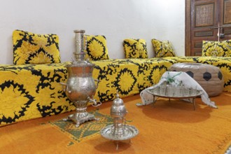 Inviting Moroccan sitting area with elaborate tea set on a decorative tray, Bahia Palace in