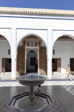 Quiet courtyard with fountain and traditional Moroccan architecture under clear skies, Bahia Palace