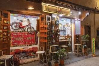 Colourful cafe with decoration and lights, a wheel hanging on the wall