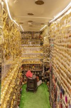 Tight shop full of shiny golden decorations and traditional goods