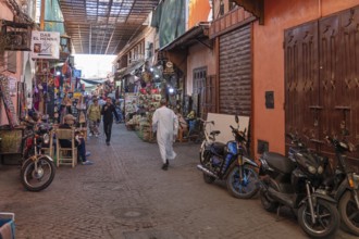 Alley with motorbikes and lively alleyway scenery in a market area