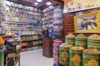 A shop with a variety of spices and products on shelves, traditionally furnished