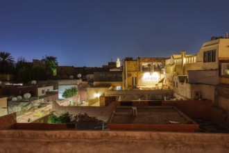 View of an urban landscape at night from a roof terrace