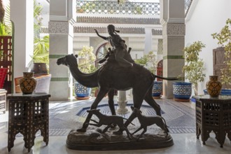 Decorative camel statue with rider in an area with ornate tiles
