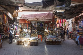 Market scene in Morocco with numerous souvenir stands and colorful cloths