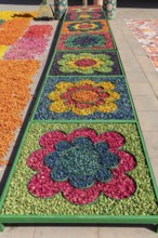 Colourful floral arrangements in geometric patterns at a market