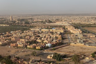 Aerial view of a city in the desert with characteristic orange buildings and architectural