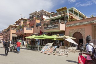 Busy street with shops, café and strolling people