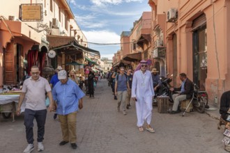 Busy street with people strolling between culturally influenced buildings