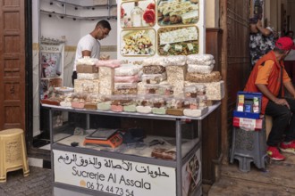 A stall full of colorful oriental sweets at a market