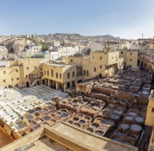 View of a traditional tannery in the old town of Fez under clear skies