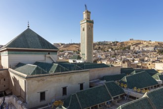 City landscape with Islamic architecture and distinctive minaret in sunlight