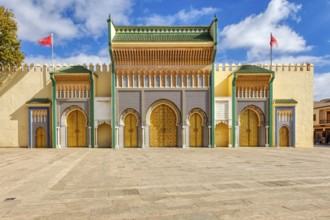 Detailed view of an ornate palace entrance with colorful mosaics and arches