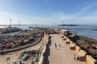 Harbour view with boats and historic walls in calm, clear weather