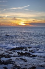 Sunset over the sea with intense colors and calm water