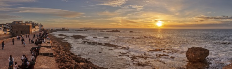 Atmospheric panorama of sunset over the coast with city view