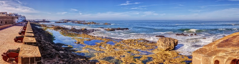 Panorama of a rocky coast with clear blue sky