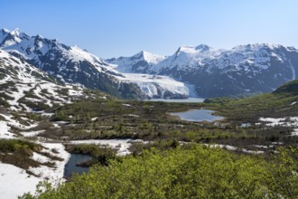View from Portage Pass of Divide Lake, snowy mountain peaks and glaciers Portage Glacier, Portage