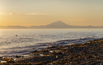 View of Cook Inlet on white mountain peaks of Mount Redoubt at sunset, midnight sun, Aleutian