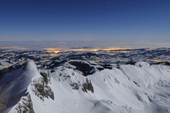 Night shot, long exposure of the 2506 meter high Säntis into the wintery, snow-covered, fog-covered