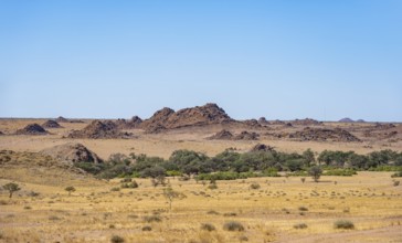 Desert landscape, barren landscape with hills of stacked rocks, Ugab River riverbed, Brandberg,