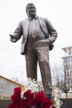 Walter Lübcke memorial with red roses and a mourning ribbon at the erection of Walter Lübcke Platz